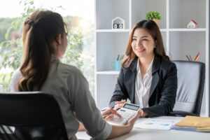 Businesswoman consulting work on taxes and income calculations together to brainstorm work ideas.