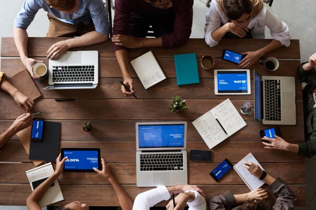 Team collaborating on laptops — Dmagic process